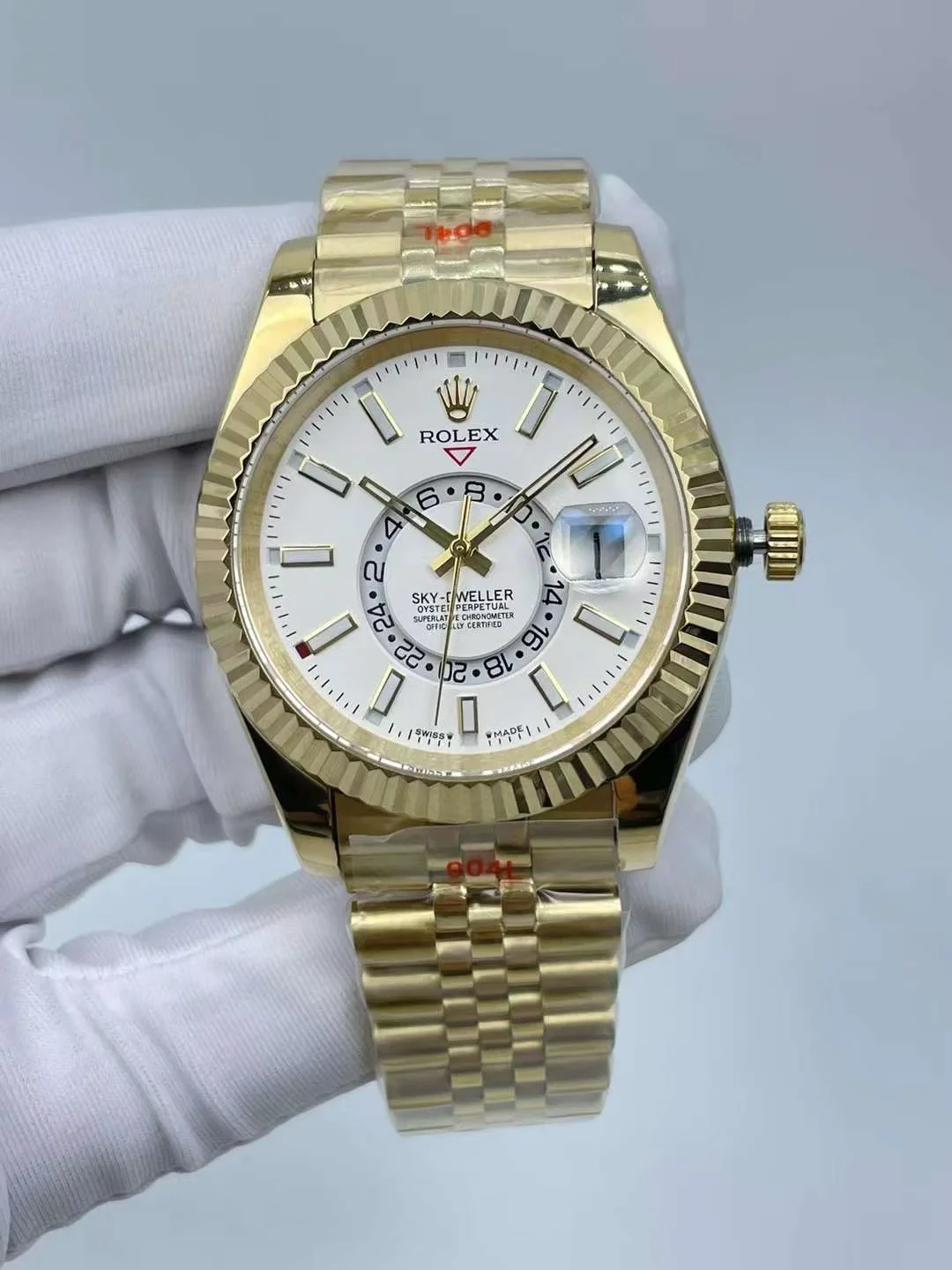 Rolex Sky-Dweller luxury watch with yellow gold case and white dial