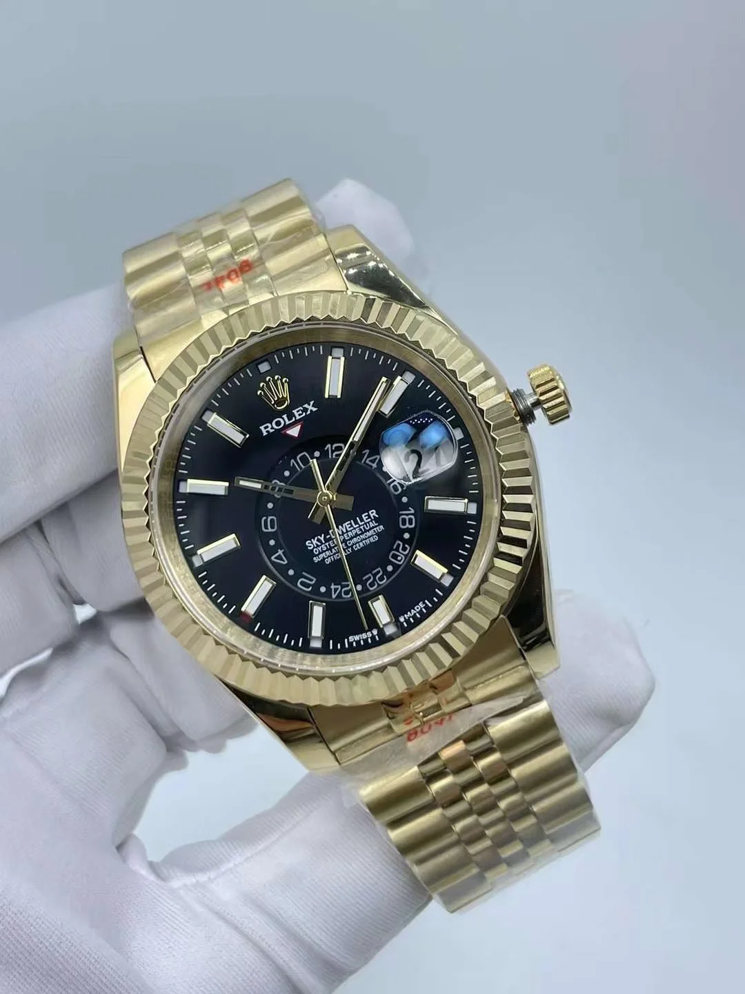 Luxury gold mens mechanical watch with dark dial showing date window display